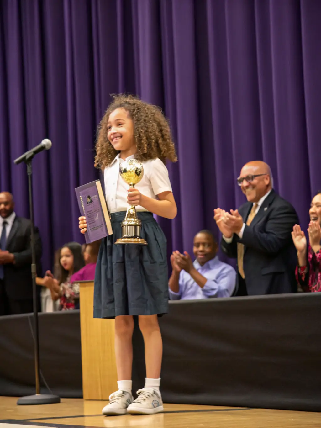 A student receiving an award at a sports event, highlighting the association's commitment to recognizing and celebrating student achievements.
